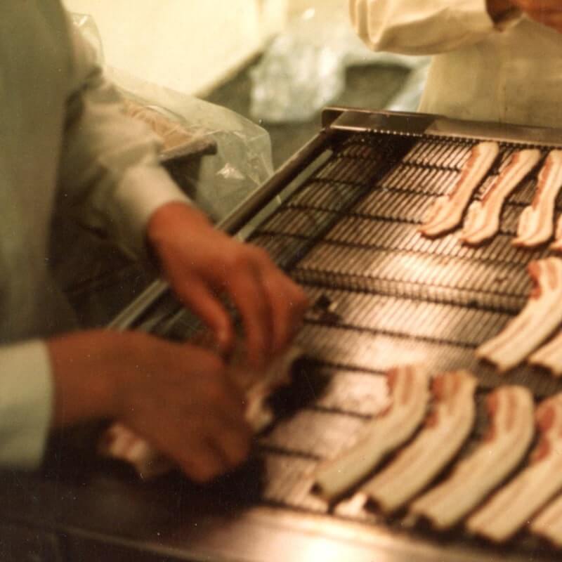 Industrial grill with bacon rashers